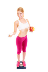 Woman holding vitamins and apple. Health care.