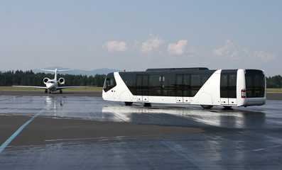 Airport bus near the small airplane