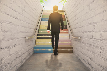Businessman walking on suitcase stairway concept