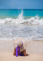 woman with straw hat on the beach