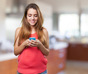 happy young cute woman typing a text on mobile on white