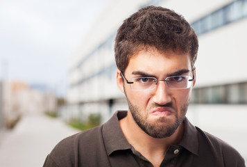 portrait of angry man over abstract background