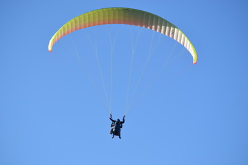 Back view of a couple paragliding