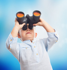portrait of a little boy looking through the binoculars