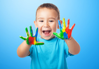 portrait of cute kid playing with paint