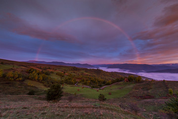 Fototapeta na wymiar rainbow at sunrise in mountains