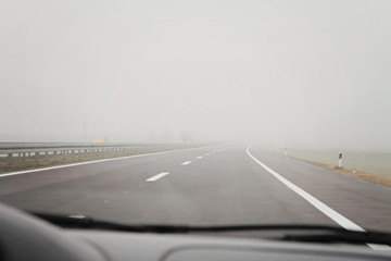 Car Driving In Very Thick Fog. Foggy road