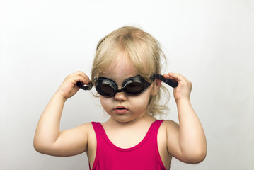 Little blond girl in a pink bathing suit cohesive