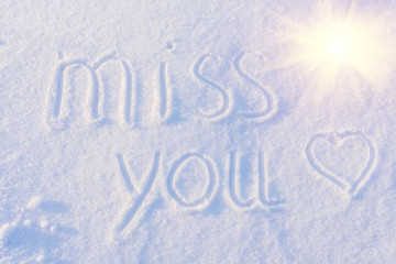 Miss you written on snow