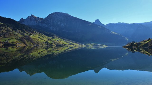 Beautiful shaped mountains mirroring in lake Wagital