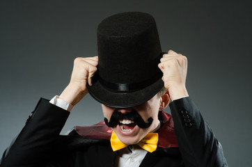 Funny magician man wearing tophat