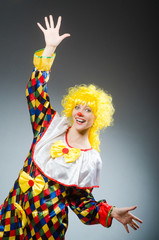 Clown in funny concept on dark background