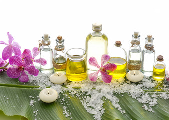 Obraz na płótnie Canvas health spa with bottle oil, candle, orchid and banana leaf