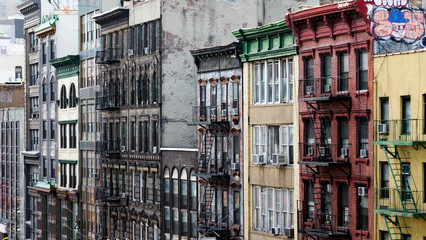 Naklejka premium Colorful Buildings Line a Block in Chinatown, New York City