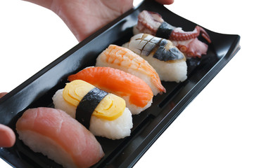 hand holding sushi plate isolated on white background