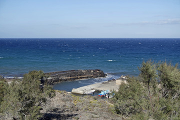 natural black lava beach koulombos on santorini island