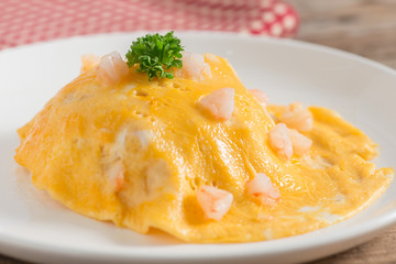 Scrambled egg shrimp on white plate.
