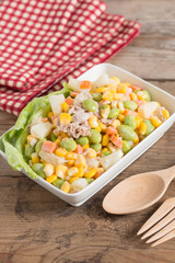 Tuna corn salad in white bowl.