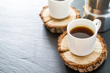 Coffee in white cups on wood boards