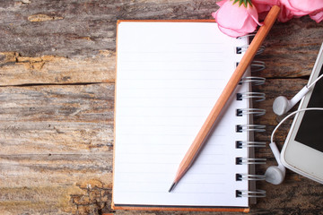 Blank notepad with pencil and earphone
