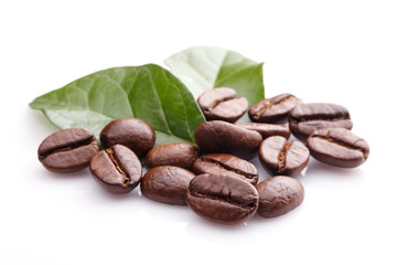 Close up coffee grains and leaves on white background
