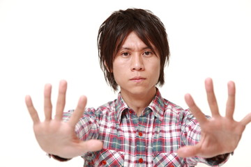  young Japanese man making stop gesture