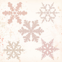A set of beige grunge snow flakes on textured vintage background. Vector illustration.