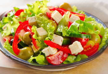 Fresh   salad with feta and olives  .