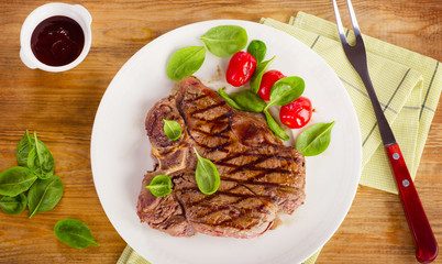 Grilled beef steak served with  fresh vegetables and a BBQ  ketc
