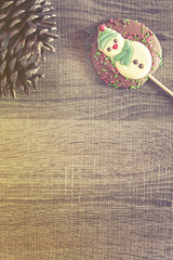 Christmas frame with chocolate figure on a wooden background