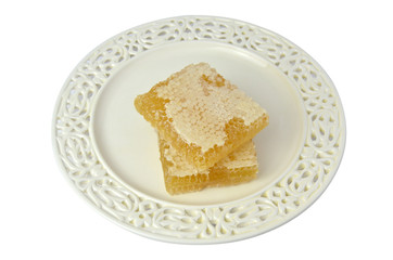 Hresh honeycomb on fine porcelain plate, on white