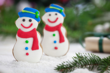 Christmas gingerbread snowman cookies on a bed of snow with copy space