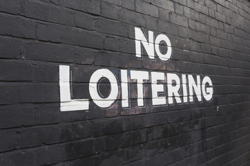 No Loitering sign painted on wall