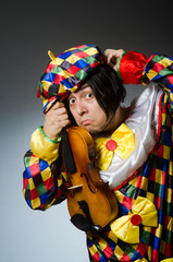 Funny violin clown player in musical concept