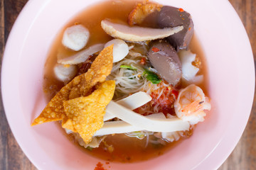 Noodles with seafood soup and red sauce