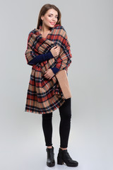 Full length portrait of a happy woman with plaid