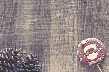 Christmas frame with chocolate figure on a wooden background