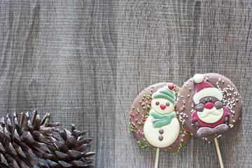 Christmas frame with chocolate figures on a wooden background