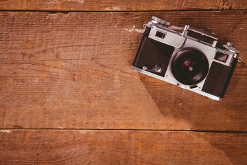 Old school camera on wooden floor