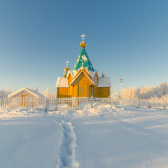 Snow trail leading to a wooden Orthodox Church winter, snow.