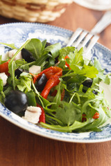 Arugula salad with turkey meat, baked capsicum and olives