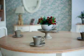 Cup of coffee and flowers on the wooden table