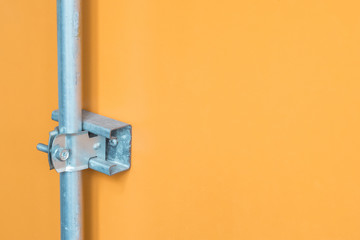 metal joint detail. on yellow wall