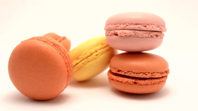 hands catching a big plate of macarons