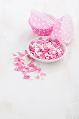 colored sugar hearts and paper baking dishes 