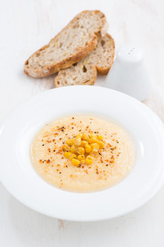 corn soup in plate and bread vertical
