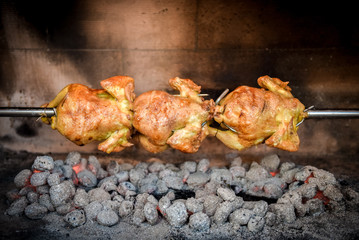 Cooking 3 rotisserie chicken on the grill with Charcoal and Briq