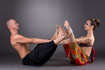 Image of man and woman doing yoga together