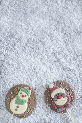 Christmas frame with chocolate figures on a snowy background
