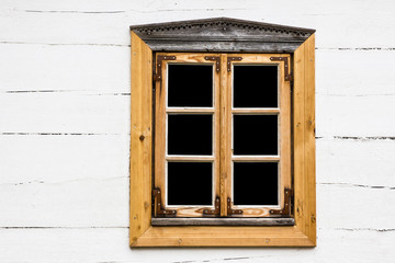 Small window in wooden village house cottage.